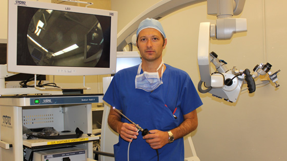 Image of Dr. Ivan Radovanovic, neurosurgeon, holds an endoscope 