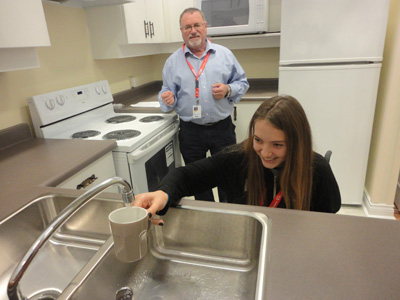 Image of Student in wheelchair getting water at Toronto Rehab