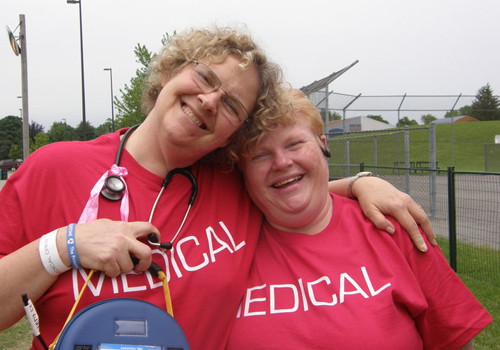 Photo of two women in pink shifts smiling for camera in story folder