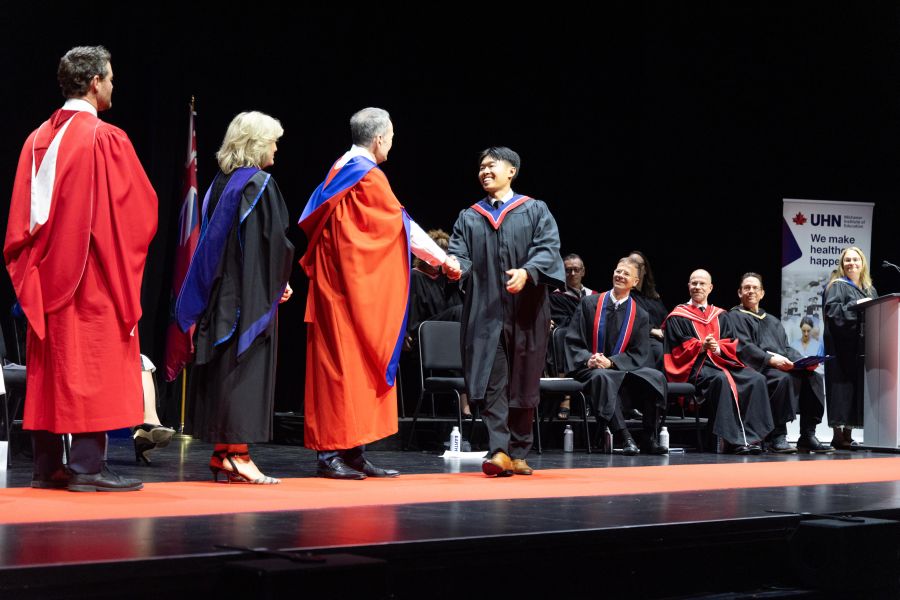 Graduate crossing stage at Michener convocation