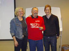 Image of Don Ramse, Heather Ross, Mike Macdonald w five year transplant pin at transplant xmas party 