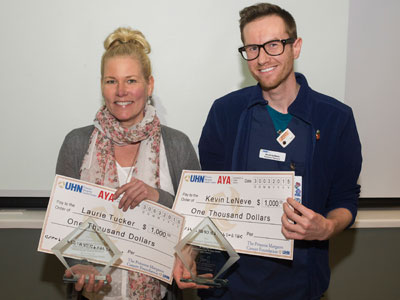Image of Laurie and Kevin holding cheques 