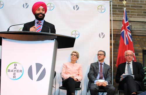 Minister Bains at the podium 