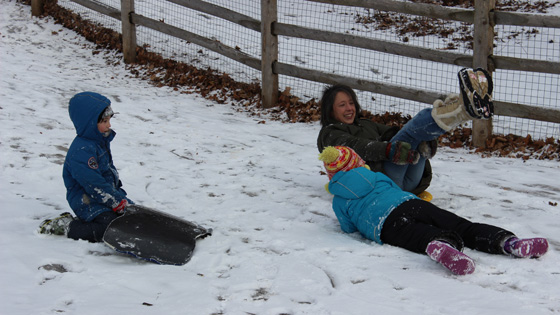 Image of Lisa playing in the snow with kids