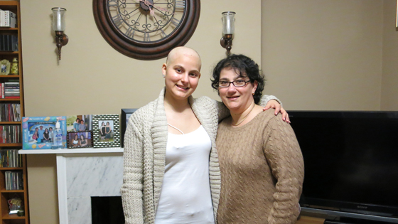Cancer patient and mother embrace.