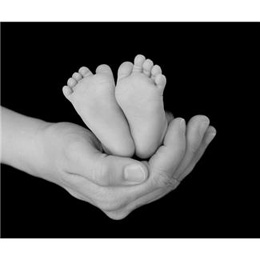 Image of a baby's feet being held by a hand