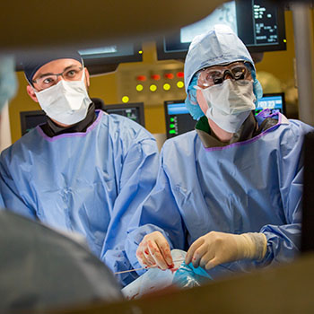 Dr. Thomas Lindsay performing life-saving aneurysm surgery