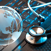 globe and medical tool on a keyboard