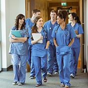 group of health professionals walking down a hospital hallway