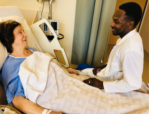 Kwaku Gyimah bedside with patient