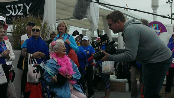 Image of Kitty Cohen (C), a 102-year-old participant, receives the Heart & Sole Award 